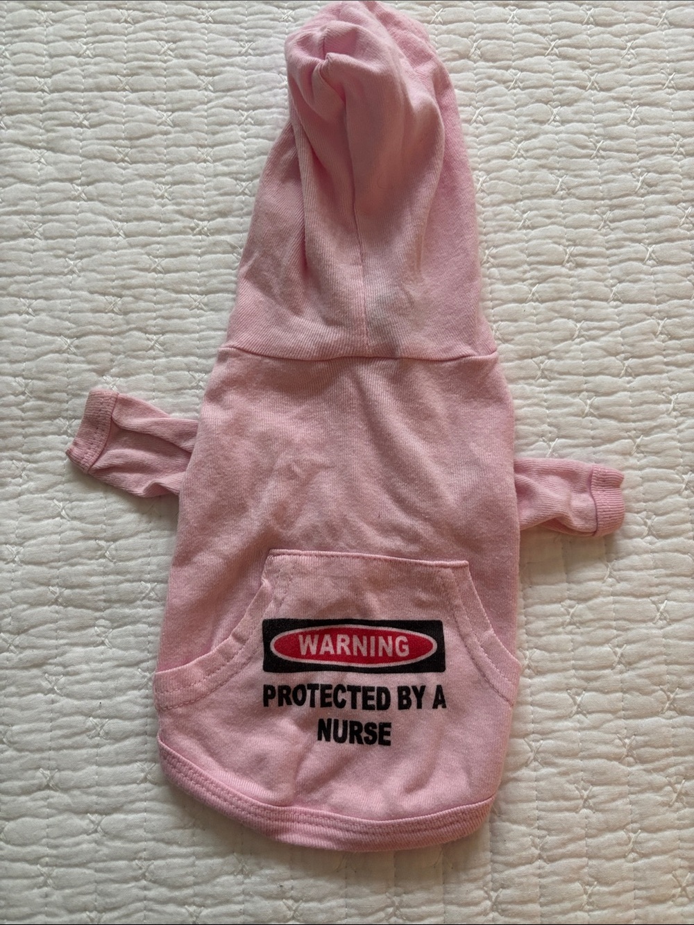 5/$15! Pink hooded dog shirt with saying, “Protected by a Nurse" S